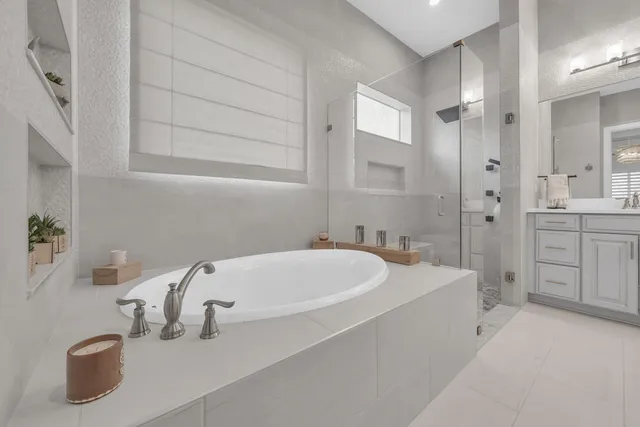 a spacious bathroom with a double vanity sink and a mirror