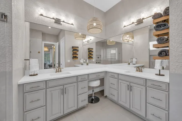 a spacious bathroom with a double vanity sink a mirror and a shower