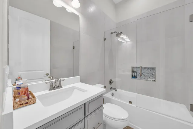 a bedroom with bed and a chandelier