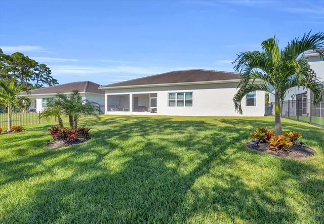 a yard with swimming pool and green space