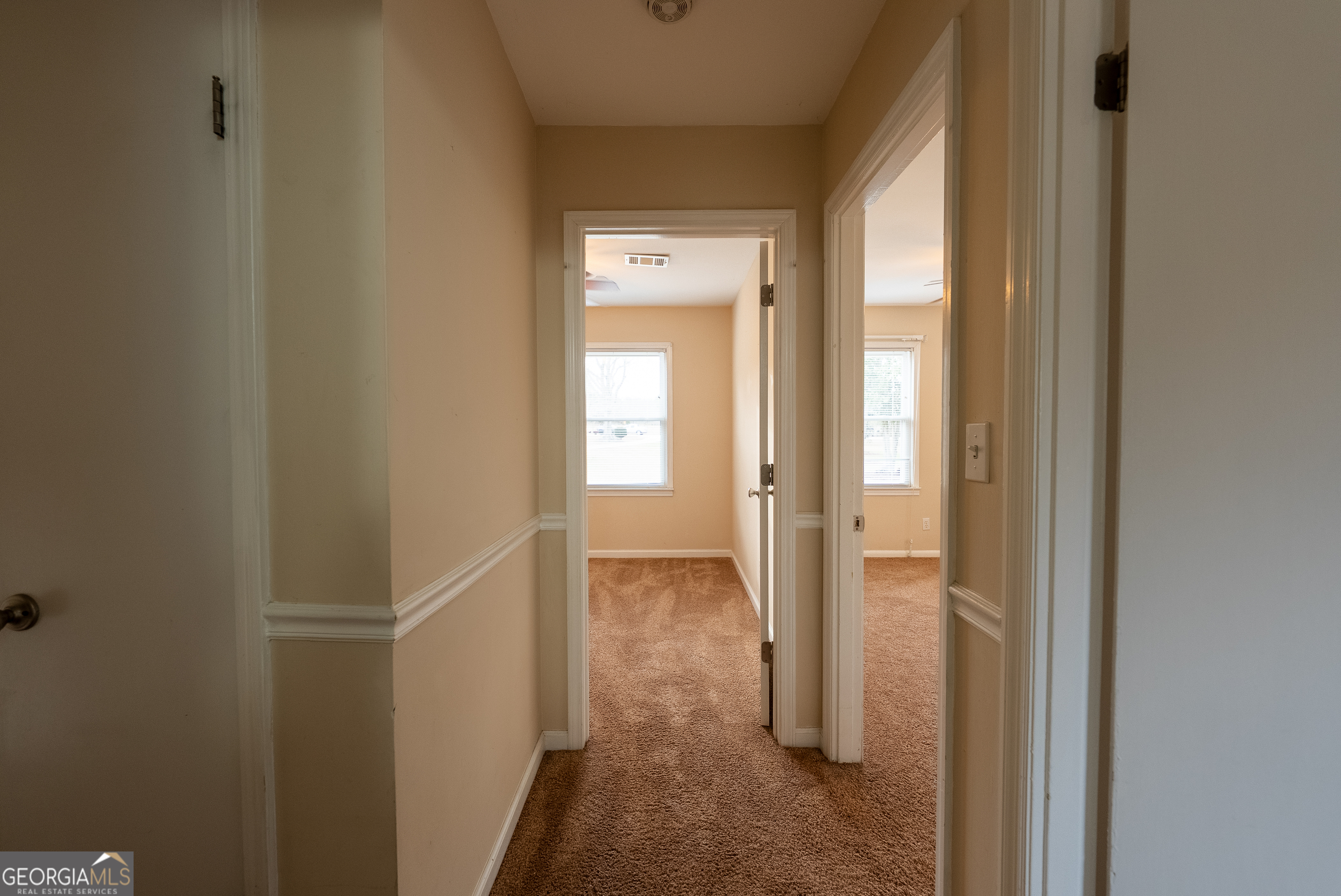 953 McCullough Road Stockbridge, GA 30281 - Photo 9 of 29 a view of a hallway with wooden floor and a bathroom