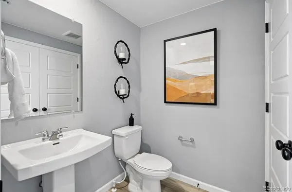 a en suite bathroom with a granite countertop sink and a mirror