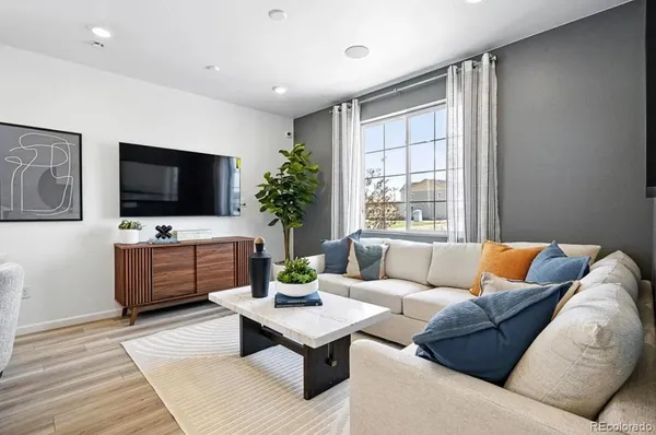 a living room with furniture and a large window