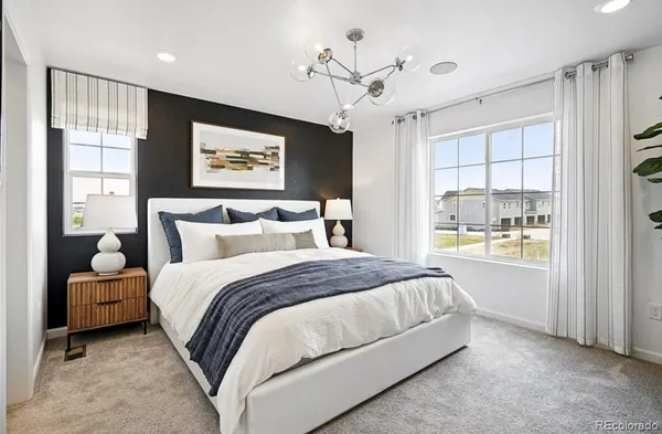 a large kitchen with stainless steel appliances granite countertop a stove a sink dishwasher a dining table and chairs with wooden floor