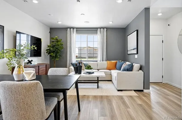 a kitchen with a table chairs refrigerator and cabinets