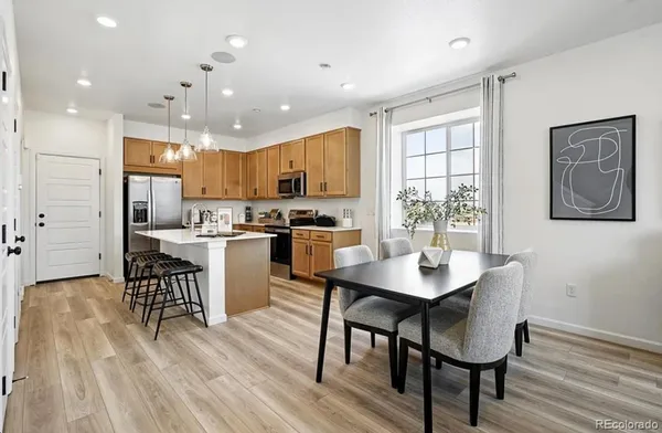 a kitchen with a sink a microwave a refrigerator and cabinets