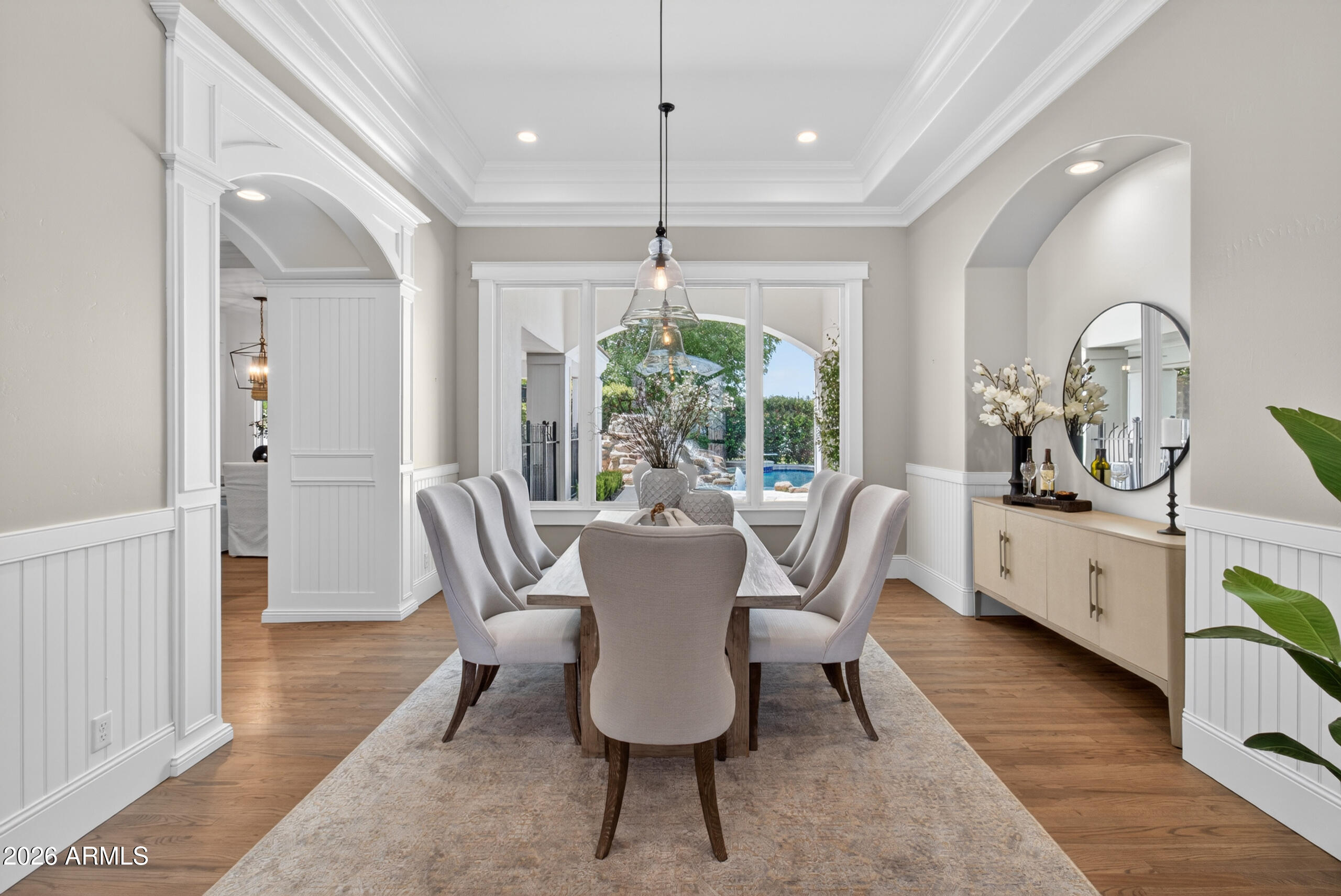 2677 East Queen Creek Road Gilbert, AZ 85297 - Photo 18 of 128 a dining room with furniture a chandelier and wooden floor