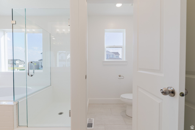 433 North 600 West Smithfield, UT 84335 - Photo 34 of 40 Bathroom featuring a glass-enclosed shower, white tile flooring, a window, and a white paneled door with brushed nickel hardware