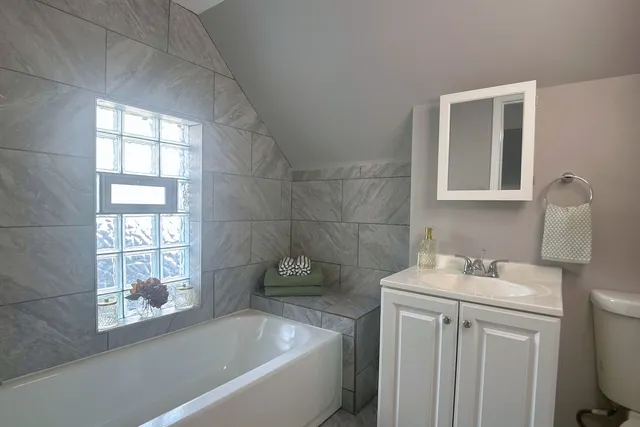 a bathroom with a sink toilet and shower