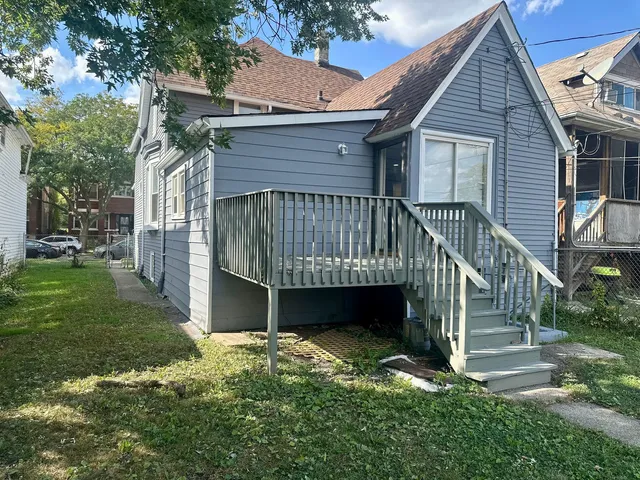 a view of a house with a yard next to a road