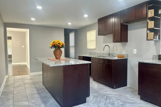 a kitchen with a sink and a refrigerator