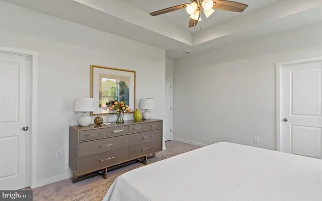 a bedroom with a bed and a chandelier fan