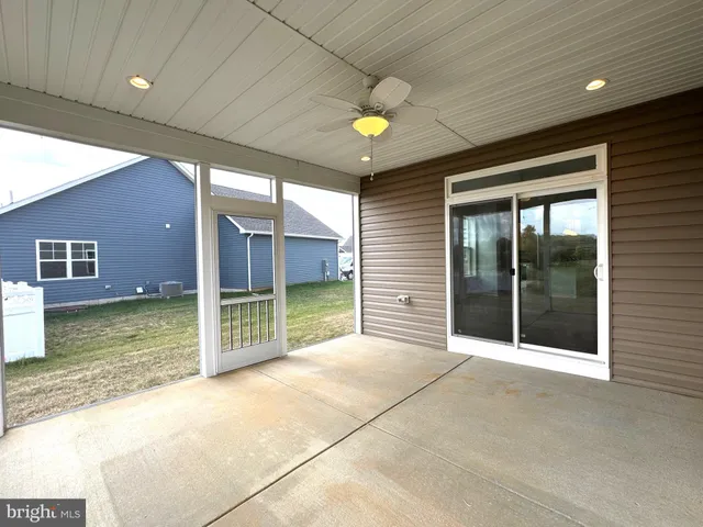 a view of a livingroom with a ceiling fan and window