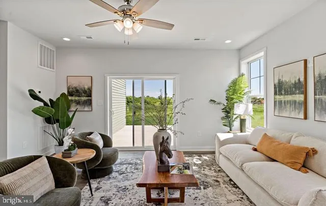 a living room with furniture lamp and window
