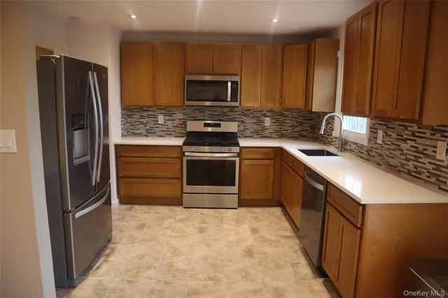 a kitchen with a sink stove and refrigerator