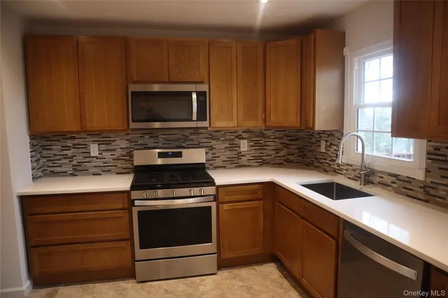 a kitchen with a stove sink and microwave