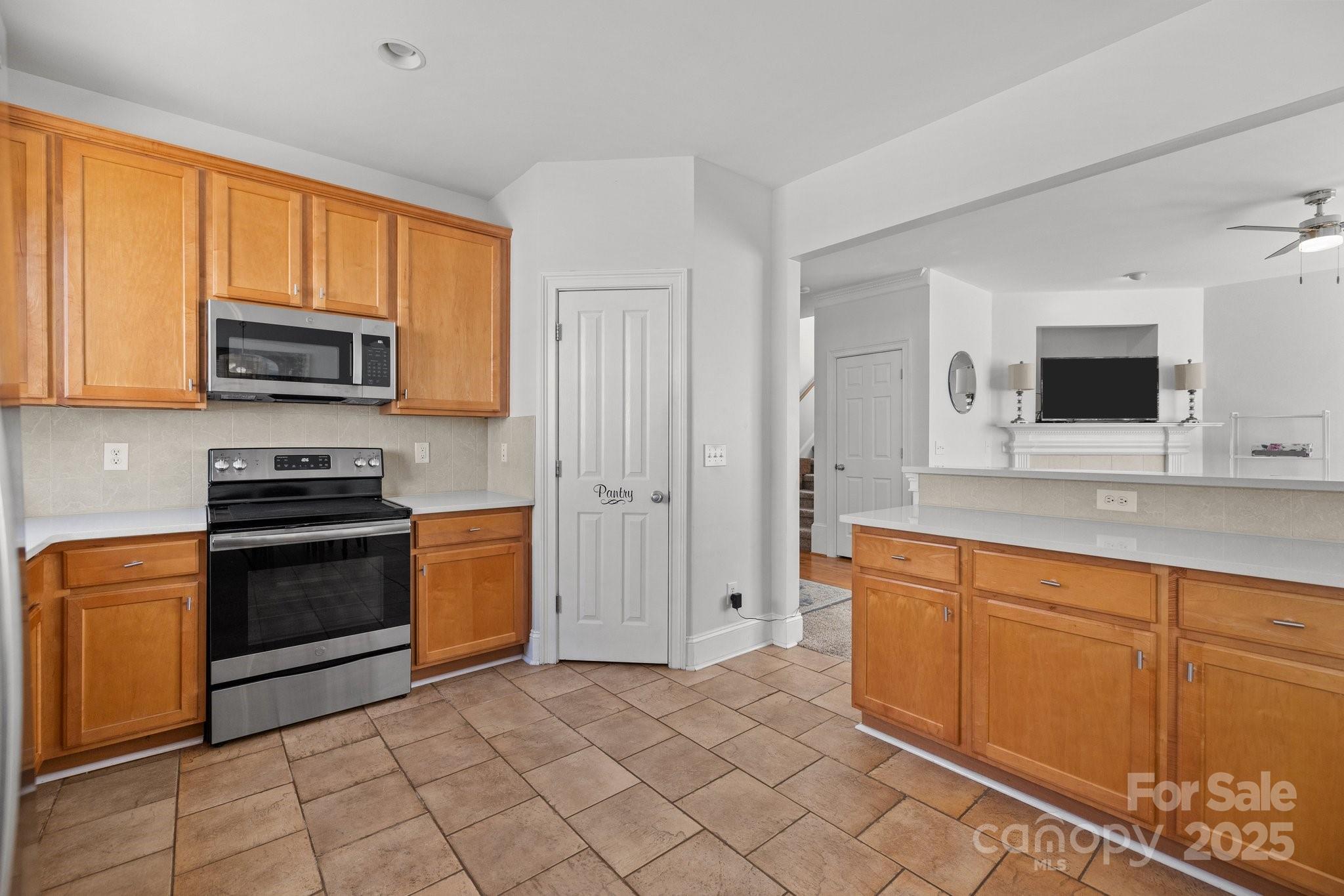3208 Fifth Baxter Crossing Fort Mill, SC 29708 - Photo 16 of 38 a kitchen with stainless steel appliances granite countertop a stove top oven a sink and dishwasher