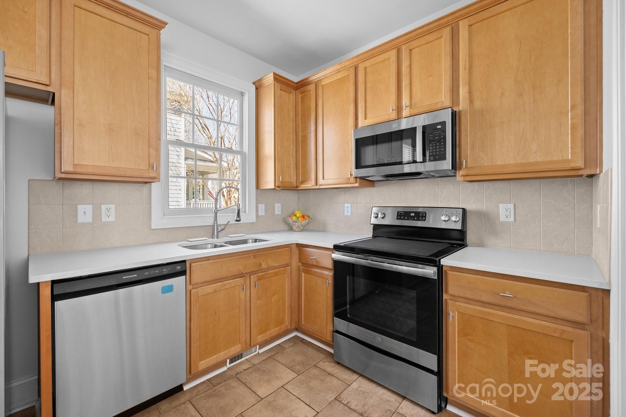 3208 Fifth Baxter Crossing Fort Mill, SC 29708 - Photo 17 of 38 a kitchen with stainless steel appliances granite countertop a stove microwave and sink