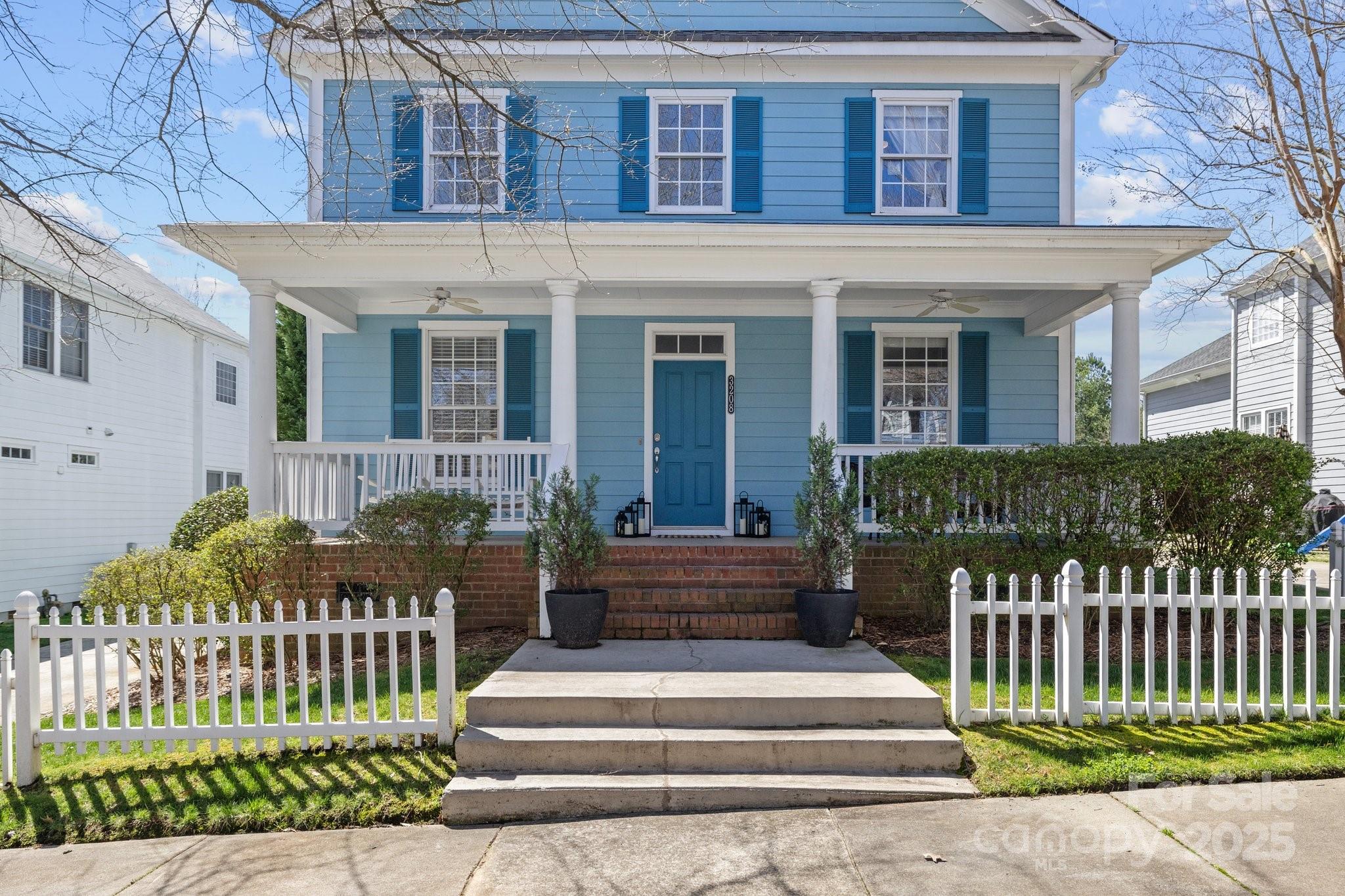 3208 Fifth Baxter Crossing Fort Mill, SC 29708 - Photo 2 of 38 a front view of a house with a garden