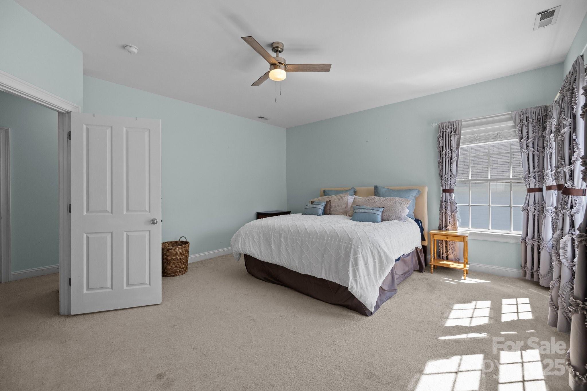 3208 Fifth Baxter Crossing Fort Mill, SC 29708 - Photo 21 of 38 a bedroom with a bed painting on wall and a large window