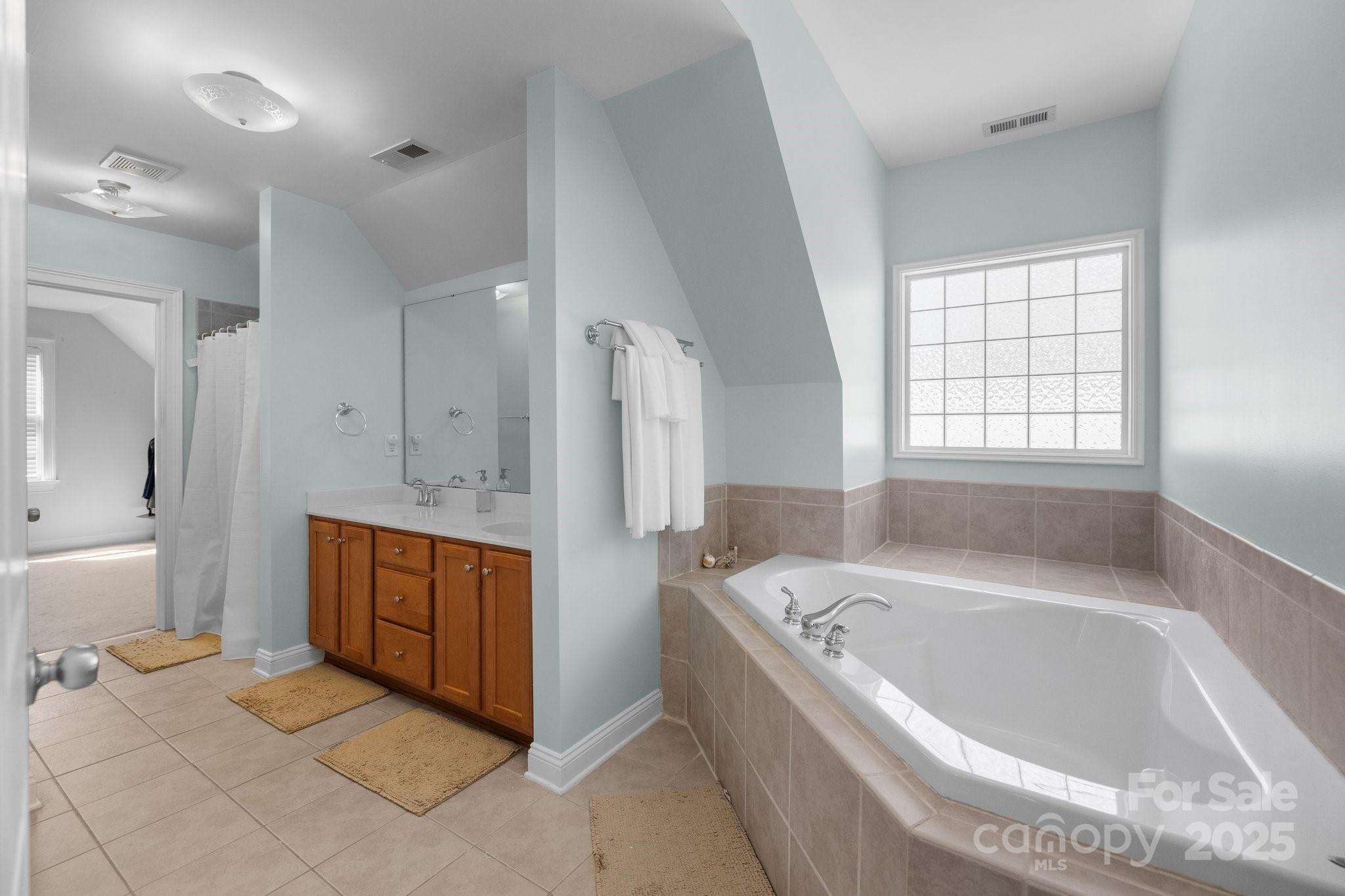 3208 Fifth Baxter Crossing Fort Mill, SC 29708 - Photo 22 of 38 a spacious bathroom with a tub sink and mirror