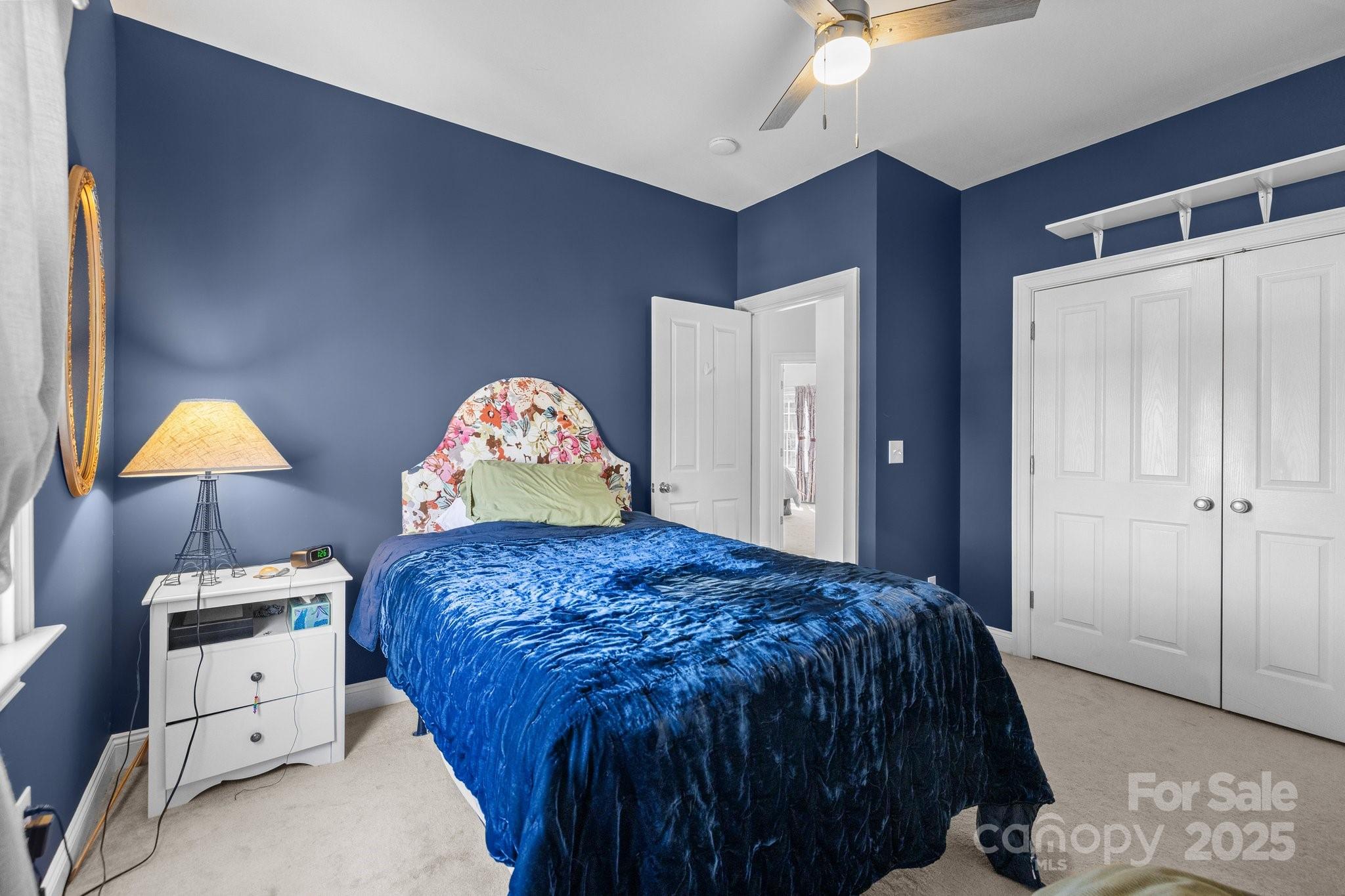 3208 Fifth Baxter Crossing Fort Mill, SC 29708 - Photo 27 of 38 a bedroom with a bed and a lamp on dresser