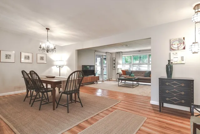a living room with furniture a rug and a table