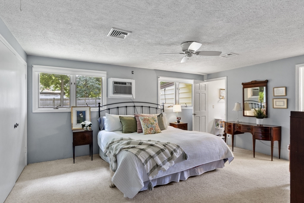 52 Lohnes Road Framingham, MA 01701 - Photo 18 of 34 a bedroom with a large bed and a chandelier