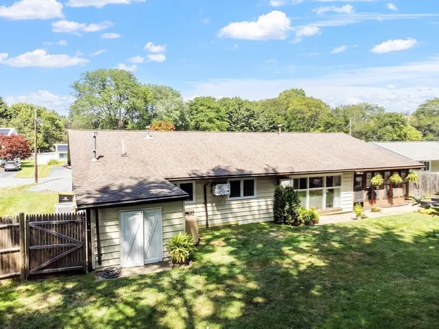 an aerial view of a house with a yard