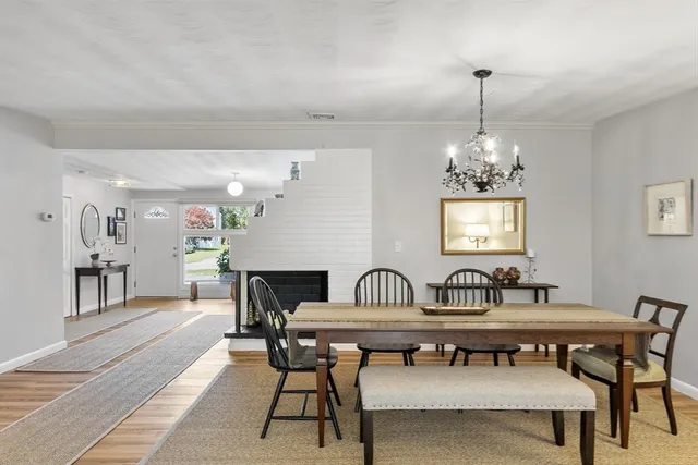 a dining room with furniture a rug and wooden floor