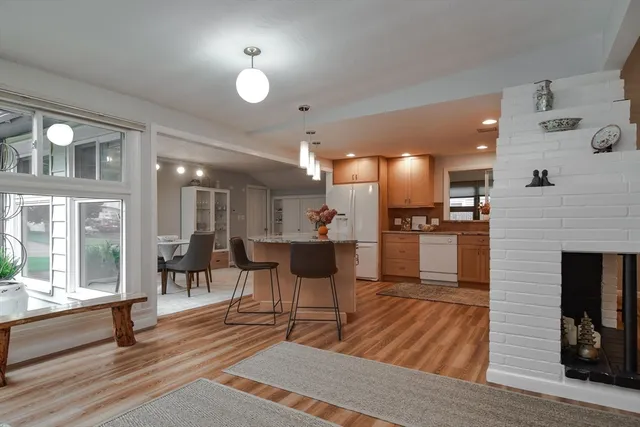 a kitchen with a sink cabinets and wooden floor