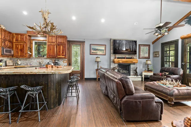 a living room with furniture a fireplace and a chandelier
