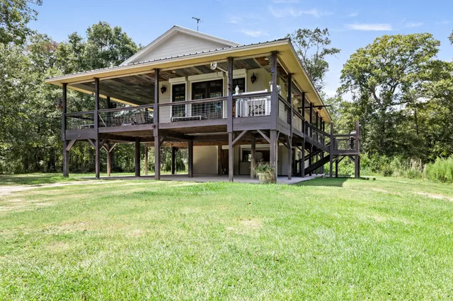 a view of a house with a yard and sitting area