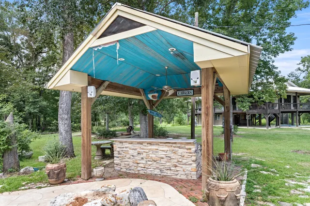 a view of a house with backyard and a patio