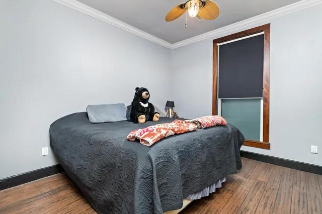 a bed sitting in a bedroom next to a window