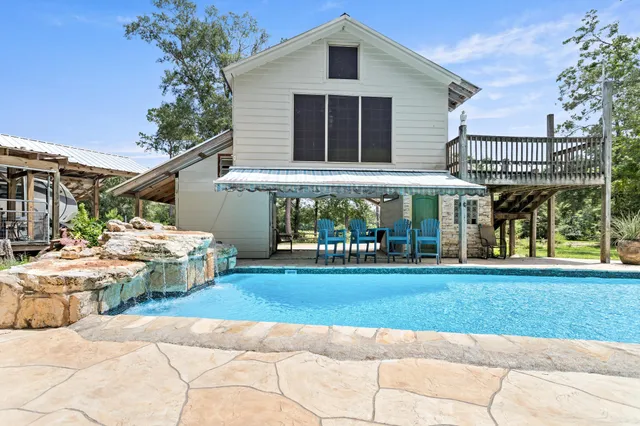a front view of a house with a yard table and chairs