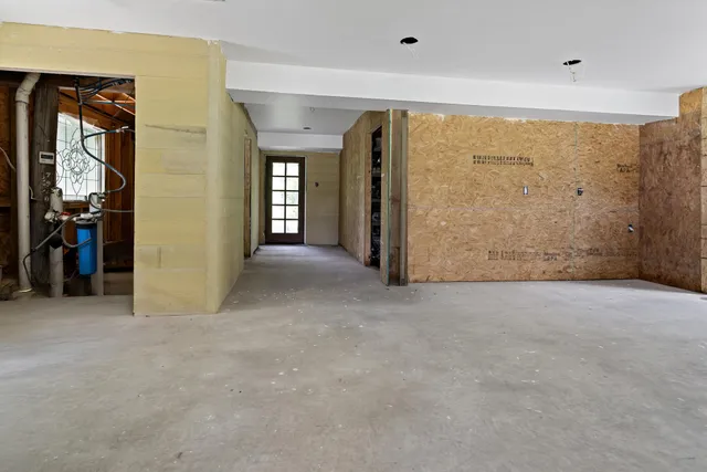a view of a hallway with wooden shelves