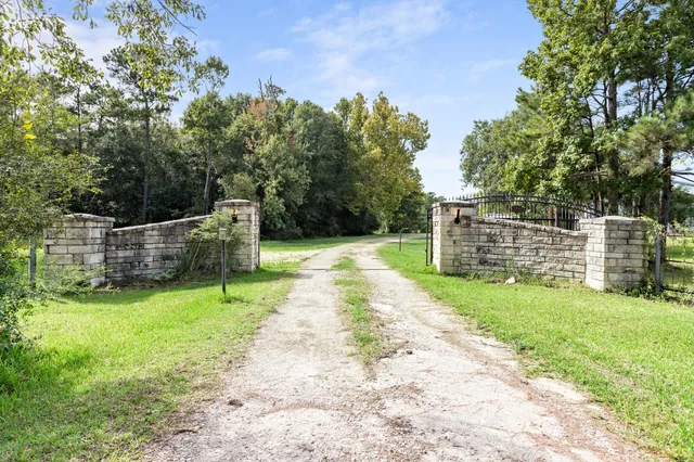 a view of a backyard with wooden fence and a bench
