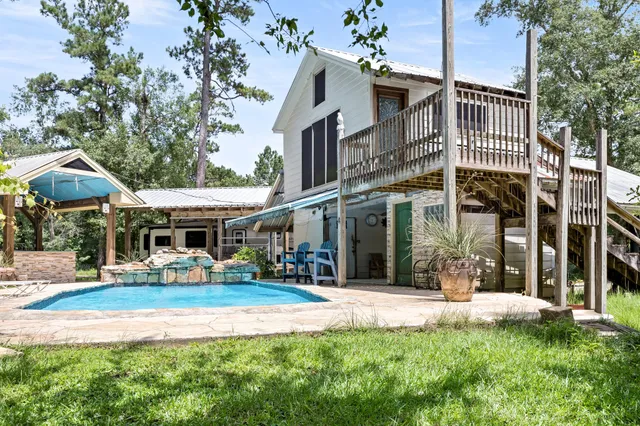 a front view of a house with a yard table and chairs