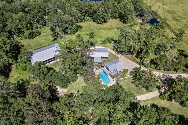 an aerial view of a house with a yard