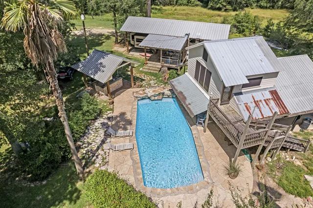 an aerial view of a house with backyard
