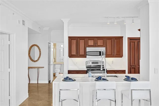 a kitchen with granite countertop a sink stove and cabinets
