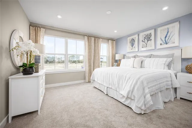 a spacious bedroom with a large bed and a window