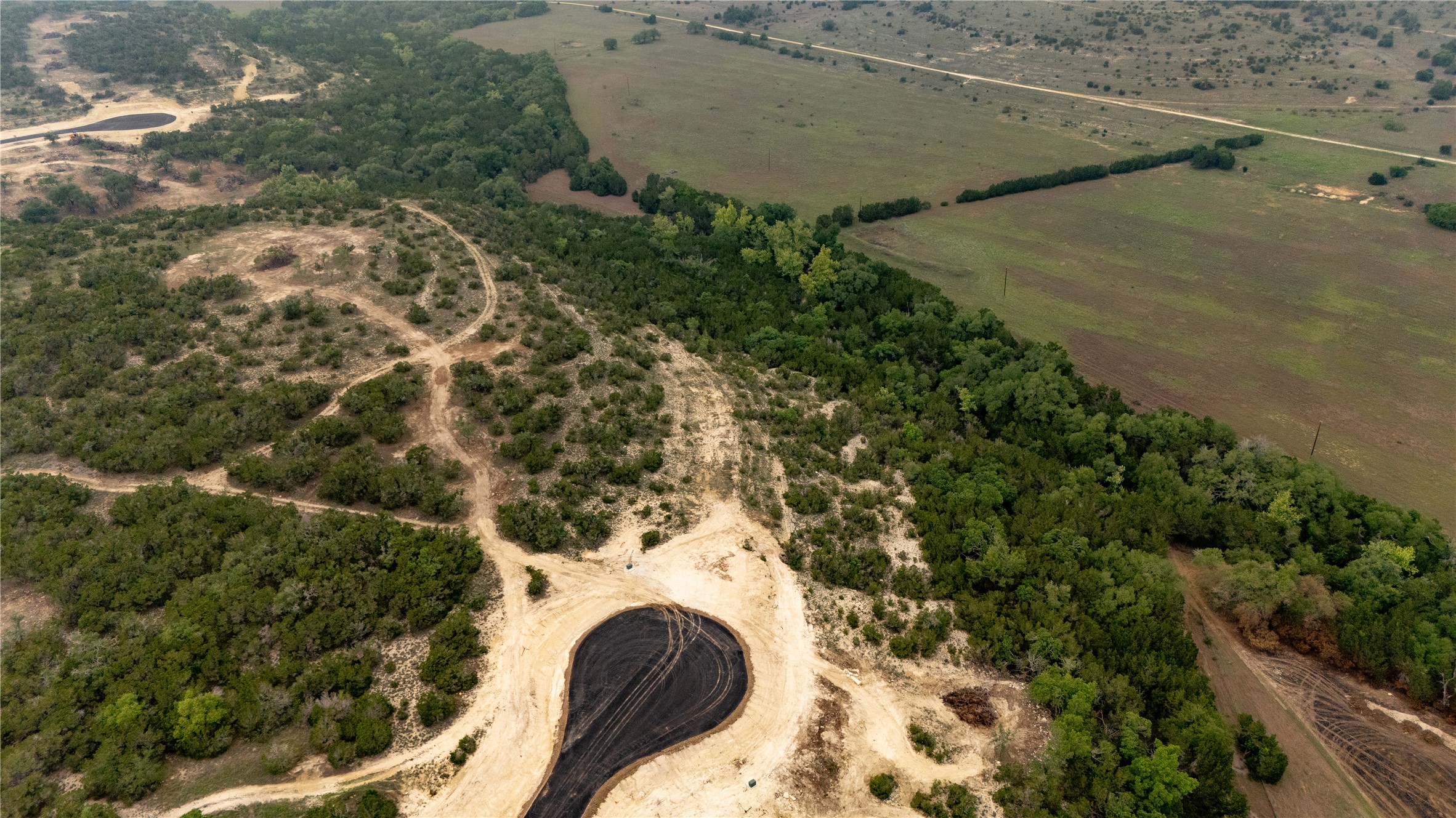 Lot 24 Ranch Road 165 Dripping Springs, TX 78620 - Photo 3 of 13 an aerial view of a house with a yard and lake view