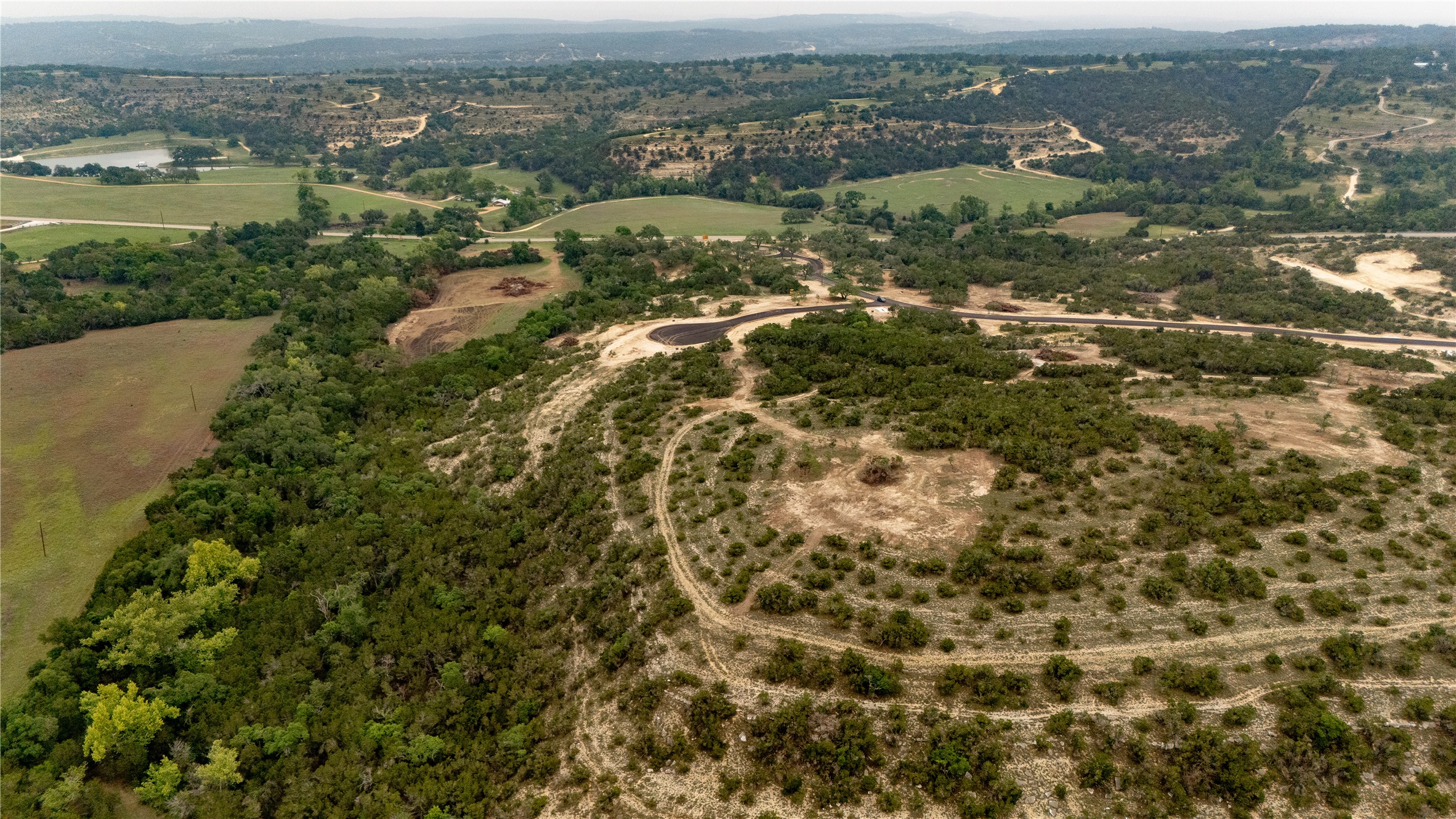Lot 24 Ranch Road 165 Dripping Springs, TX 78620 - Photo 4 of 13 an aerial view of residential houses with outdoor space and trees