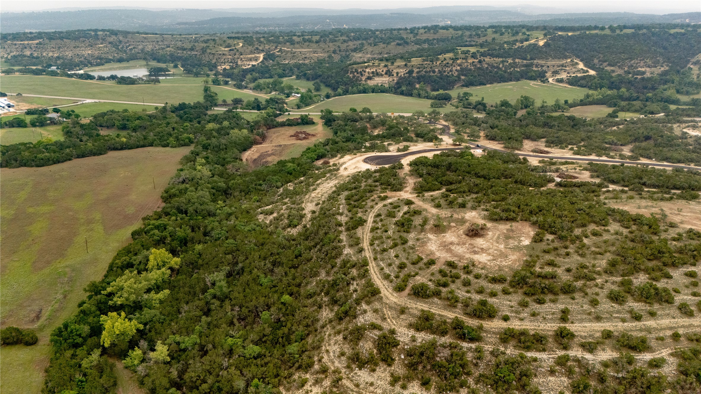 Lot 24 Ranch Road 165 Dripping Springs, TX 78620 - Photo 5 of 13 an aerial view of residential houses with outdoor space and trees