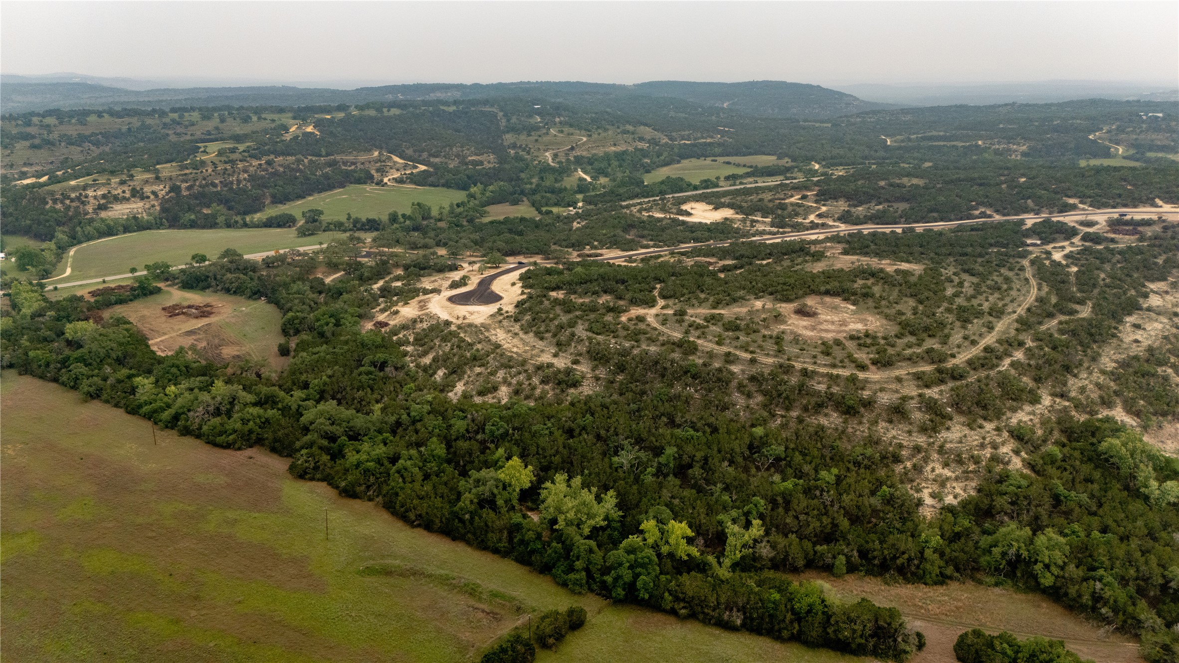 Lot 24 Ranch Road 165 Dripping Springs, TX 78620 - Photo 8 of 13 an aerial view of residential houses with outdoor space and trees