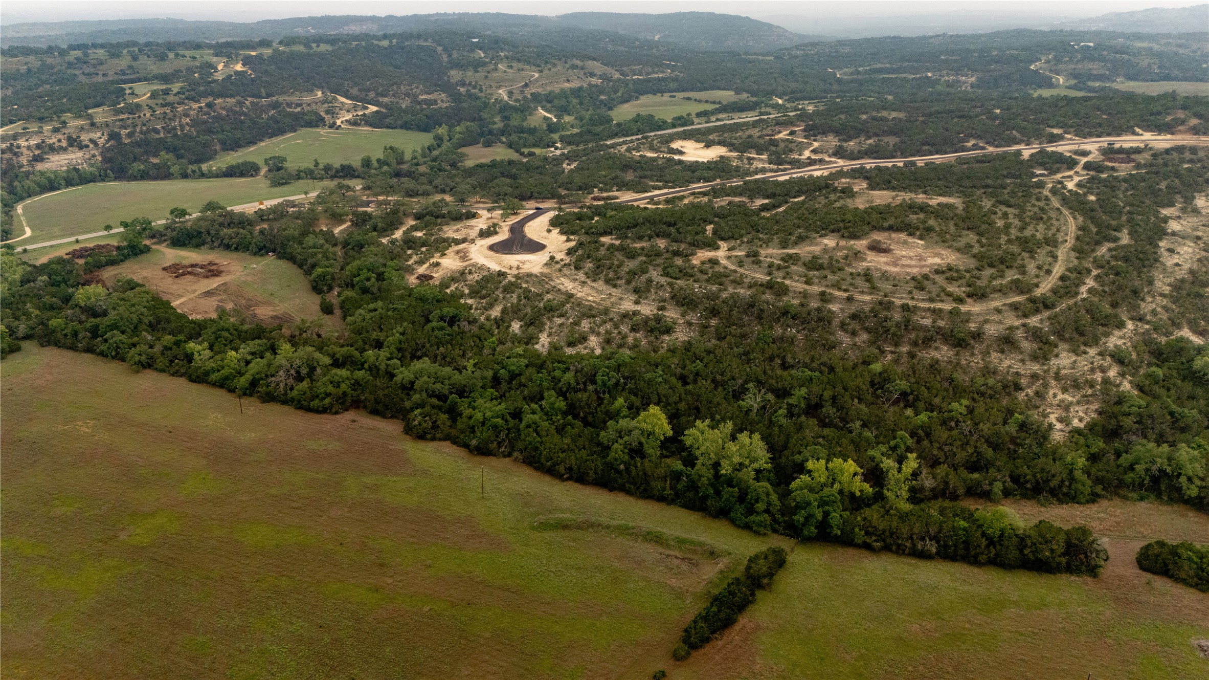 Lot 24 Ranch Road 165 Dripping Springs, TX 78620 - Photo 9 of 13 an aerial view of residential houses with outdoor space and trees