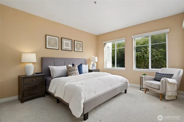 a bedroom with a bed and a couch next to a window