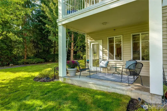a view of a house with backyard sitting area and garden